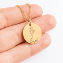 Close-up of the round pendant engraved with a rose and the name Sarah