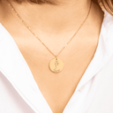 Birth flower name necklace worn with a white shirt